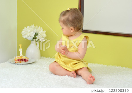 Little girl celebrating in a dress first birthday 122208359