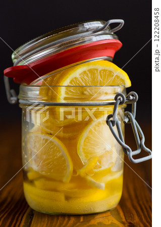 sliced lemons in sugar syrup in a glass jar, canned sliced lemons in sugar syrup in a glass jar, canned 122208458