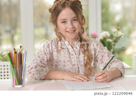 Cute smiling little girl drawing at home 122209046