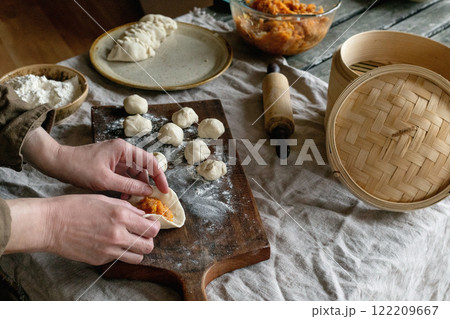 Making Asian steamed dumplings Making Asian steamed dumplings 122209667