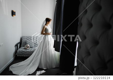 Portrait of beautiful bride with fashion veil at wedding morning Portrait of beautiful bride with fashion veil at wedding morning 122210114