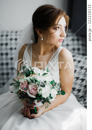 Bride holding big and beautiful wedding bouquet with flowers Bride holding big and beautiful wedding bouquet with flowers 122210115