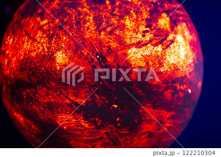 A mock-up of the planet Mars illuminated from the inside on a dark background. 122210304