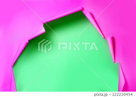 A paper pink torn background from which a green wall is visible. The photo zone in the photo studio. 122210454