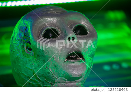 February 23, 2024. Belarus. Minsk. Educational open event about alien worlds.The alien's face is highlighted in the green color of the laboratory. The alien is a humanoid. 122210468