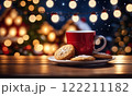 Merry Christmas and Happy Holidays. A cup of hot drink and cookies with background of the lights of Christmas market. Cup of coffee on the window sill. Bright lights of the city hristmas background. 122211182