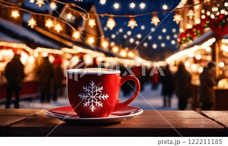 Merry Christmas and Happy Holidays. A cup of hot drink and cookies with background of the lights of Christmas market. Cup of coffee on the window sill. Bright lights of the city hristmas background. 122211185