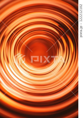 Swirling patterns of amber hues captured in mesmerizing circular motion during a sunny afternoon light play 122212102