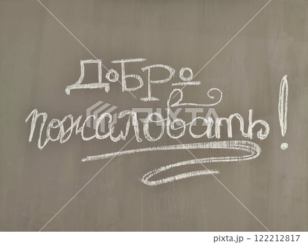 Joyful welcome message written in chalk on a classroom blackboard in Russian 122212817