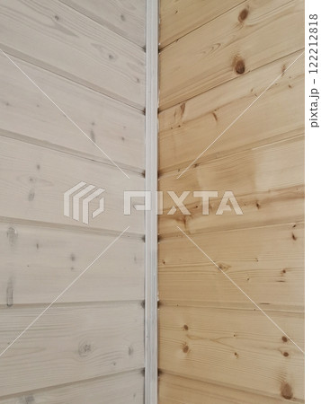 Contrast of untreated and treated wood planks showcasing natural grain patterns in a corner setting Contrast of untreated and treated wood planks showcasing natural grain patterns in a corner setting 122212818