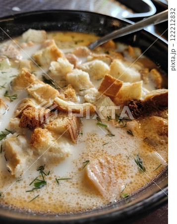 Delicious bowl of lohikeitto soup with bread croutons, close up view. Traditional Karelian and Finnish fish soup 122212832