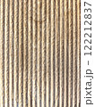 Close-up view of textured, striped surface showcasing natural wood grain in warm tones. Vertical background 122212837