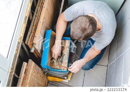 Adult man looking for tools 122213174