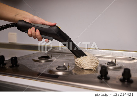 Performing a Deep Cleaning of Kitchen Equipment Using a Steam Cleaner for Hygiene and Safety Performing a Deep Cleaning of Kitchen Equipment Using a Steam Cleaner for Hygiene and Safety 122214421