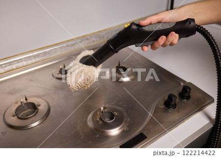Performing a Deep Cleaning of Kitchen Equipment Using a Steam Cleaner for Hygiene and Safety 122214422