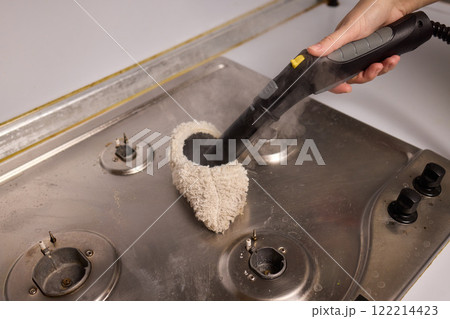 Performing a Deep Cleaning of Kitchen Equipment Using a Steam Cleaner for Hygiene and Safety 122214423