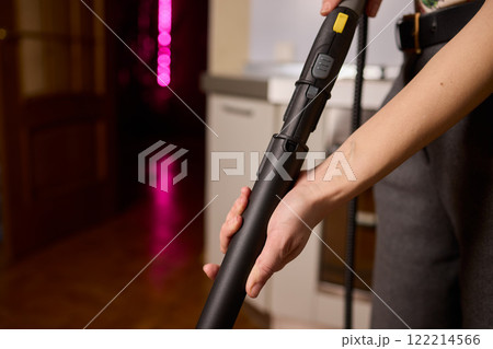 Hands actively using a vacuum cleaner in a...の写真素材 [122214566] - PIXTA