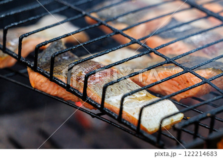 Delightful grilled trout fish infused with smoky flavors perfect for a summer gathering under the sun Delightful grilled trout fish infused with smoky flavors perfect for a summer gathering under the sun 122214683
