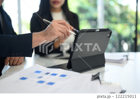 Close up of professionals business people analyzing charts and graphs on digital tablet at office Close up of professionals business people analyzing charts and graphs on digital tablet at office 122215011