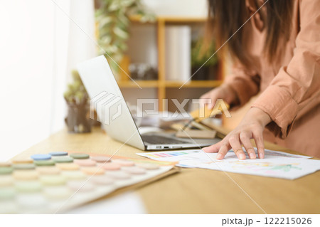 Professional interior designer or architect working with color palette design materials at desk 122215026