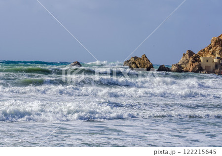 Vibrant Coastal Landscape with Crashing Waves and Sandy Shore 122215645
