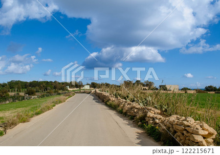 Countryside Path Under a Bright Blue Sky Rustic Charm Countryside Path Under a Bright Blue Sky Rustic Charm 122215671