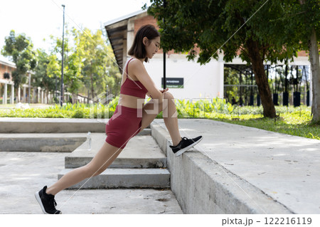 Young beautiful woman sportswear workout clothes exercise in street city park before morning run. Asian strong female sporty sportswear stretching outdoors. fitness healthy concept. Young beautiful woman sportswear workout clothes exercise in street city park before morning run. Asian strong female sporty sportswear stretching outdoors. fitness healthy concept. 122216119