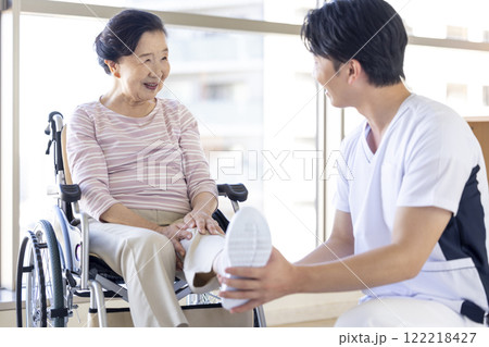 医療　理学療法士から診察を受けるシニア女性 122218427
