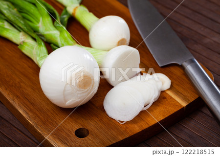 Bulb, white onions with tops closeup on table Bulb, white onions with tops closeup on table 122218515