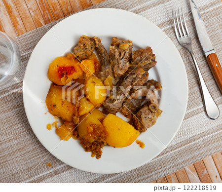 Braised rabbit served with potato garnish Braised rabbit served with potato garnish 122218519