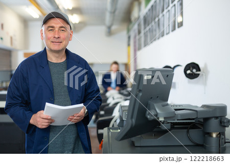 Portrait of positive man printing office worker 122218663