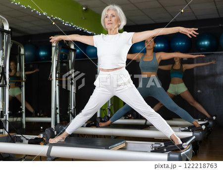 Mature woman working on posture in training Mature woman working on posture in training 122218763