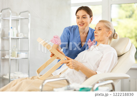 Female cosmetologist consulting senior woman before facial treatments Female cosmetologist consulting senior woman before facial treatments 122218830