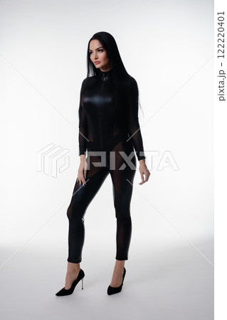 Elegant woman in black lingerie poses confidently in studio setting 122220401