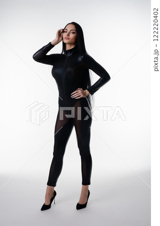 Elegant woman posing in stylish lingerie against a minimalistic studio backdrop 122220402