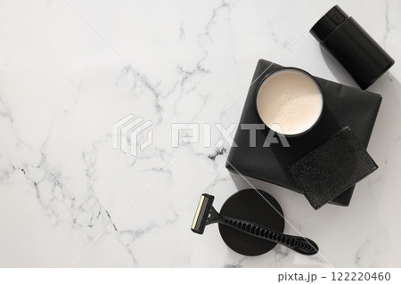 Bottle and jar with men's cosmetics, soap and razor on marble background, space for text 122220460