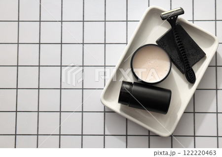 Men's razor and cosmetics bottle and jar on light background, space for text 122220463