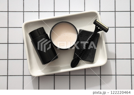Men's razor and cosmetics bottle and jar on light background, top view 122220464