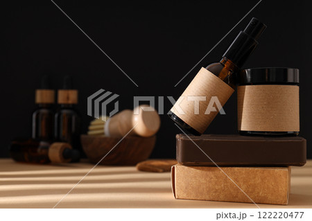 Cosmetic bottles and soap on black background, space for text 122220477