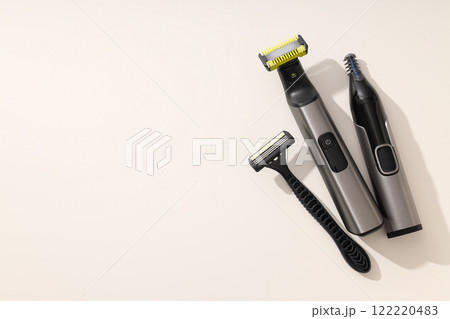 Men's electric and disposable razors on light background, space for text Men's electric and disposable razors on light background, space for text 122220483