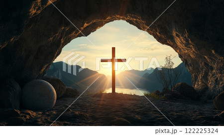 Cross is lit up in the sun in front of a mountain range 122225324