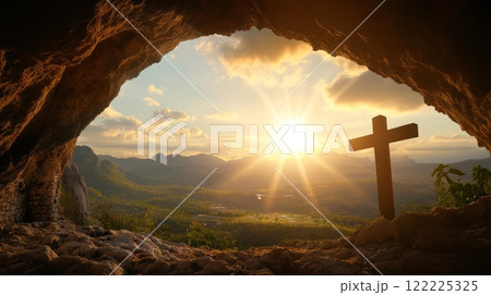Cross is lit up by the sun in a cave 122225325