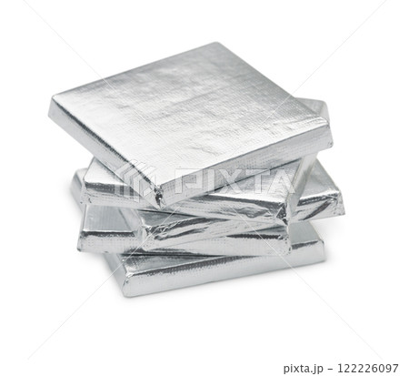 Stack of silver foil wrapped square chocolate bars 122226097