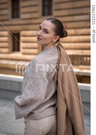 Young beautiful woman wearing coat walking in the city centre of Prague, Europe Young beautiful woman wearing coat walking in the city centre of Prague, Europe 122227901