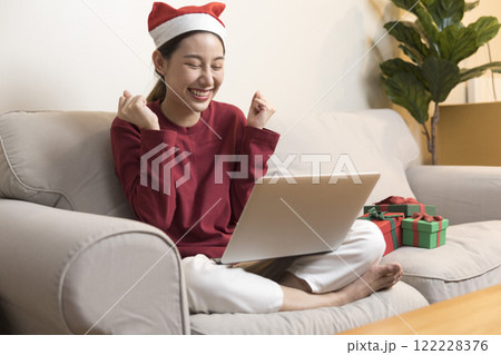 Asian pretty young woman greeting on video call during coronavirus, social distance, merry x'mas. Asian pretty young woman greeting on video call during coronavirus, social distance, merry x'mas. 122228376