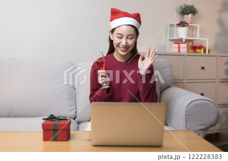 Asian pretty young woman greeting on video call during coronavirus, social distance, merry x'mas. Asian pretty young woman greeting on video call during coronavirus, social distance, merry x'mas. 122228383