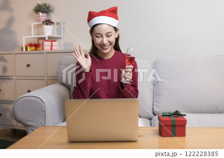 Asian pretty young woman greeting on video call during coronavirus, social distance, merry x'mas. 122228385