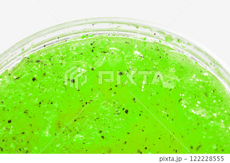 Vibrant green slime texture with black specks in close up for creative projects Vibrant green slime texture with black specks in close up for creative projects 122228555
