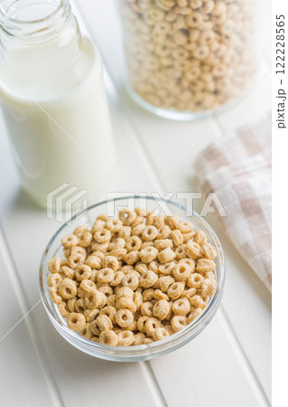 Sweet honey cereal rings in bowl on white table. 122228565