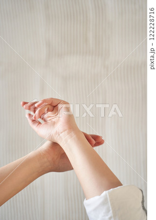 Close up of female hands in gentle pose against neutral background 122228716